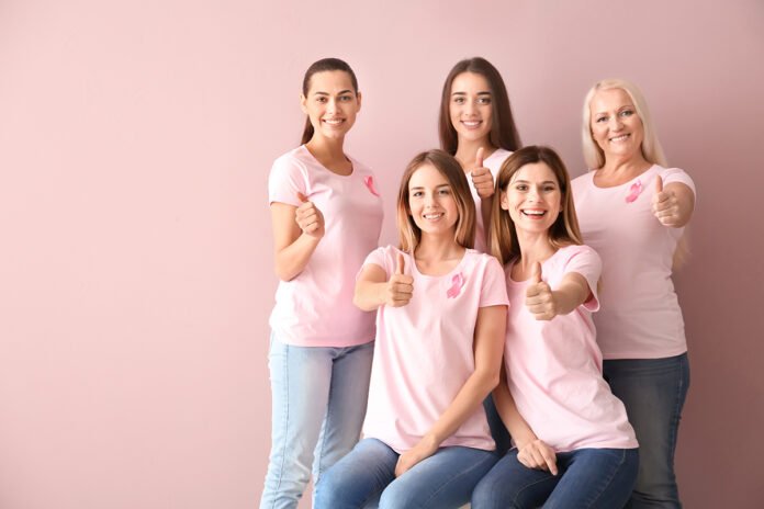 Beautiful,Women,Of,Different,Ages,With,Pink,Ribbons,Showing,Thumbs-up